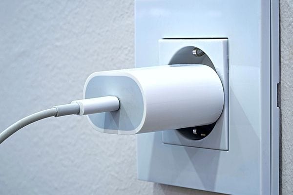 Chargeur blanc branché dans une prise murale